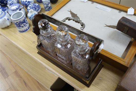 A Betjemann three decanter tantalus, with labels